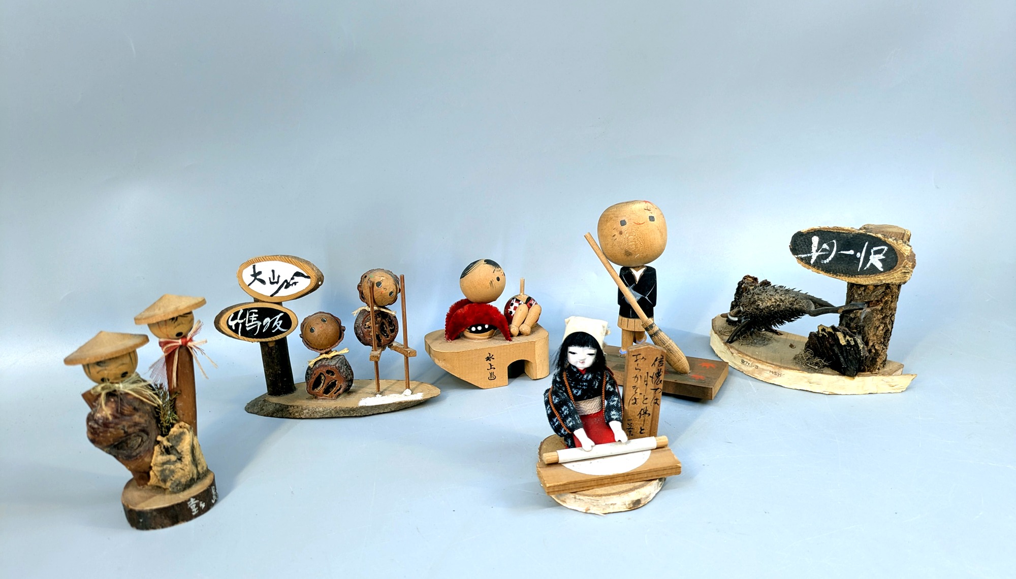 Vintage Japanese folk craft miniature village figures arranged as a set